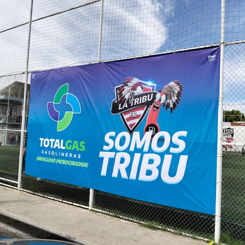Lona publicitaria instalada en cerca exterior para comunicación de marca en Ciudad Juárez